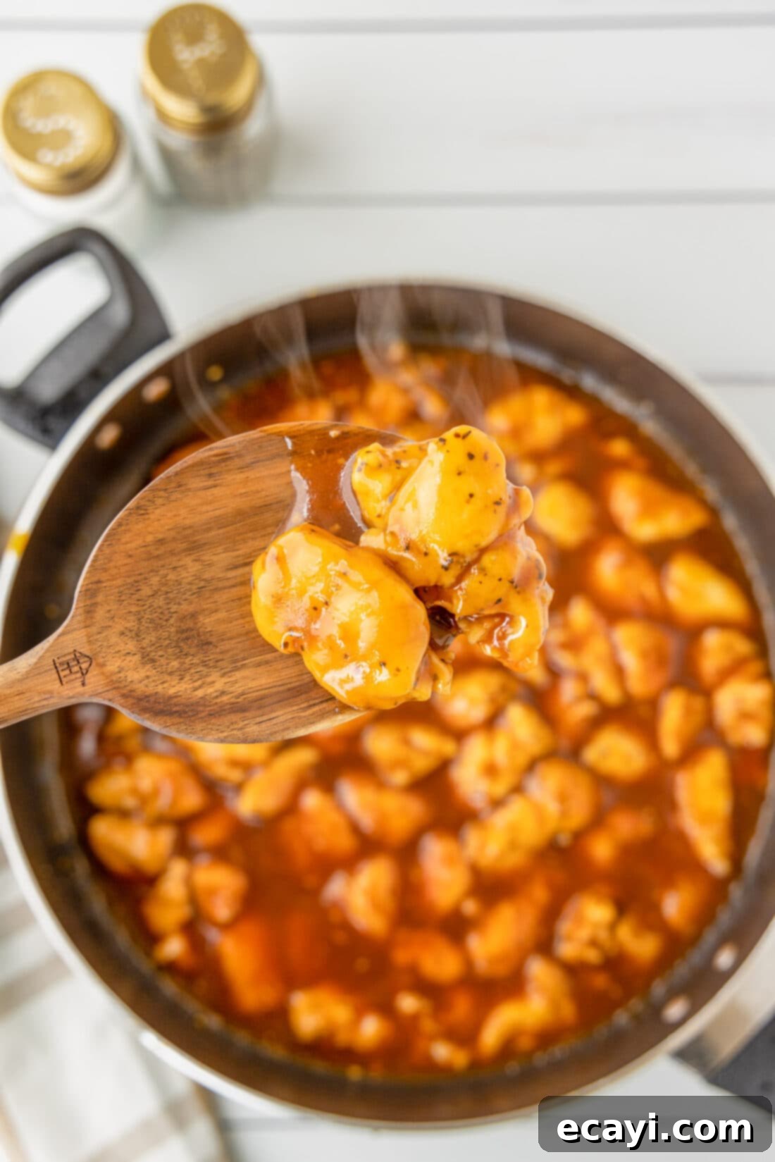 Sticky Bourbon Glazed Chicken 3 spoon of Bourbon Chicken over skillet
