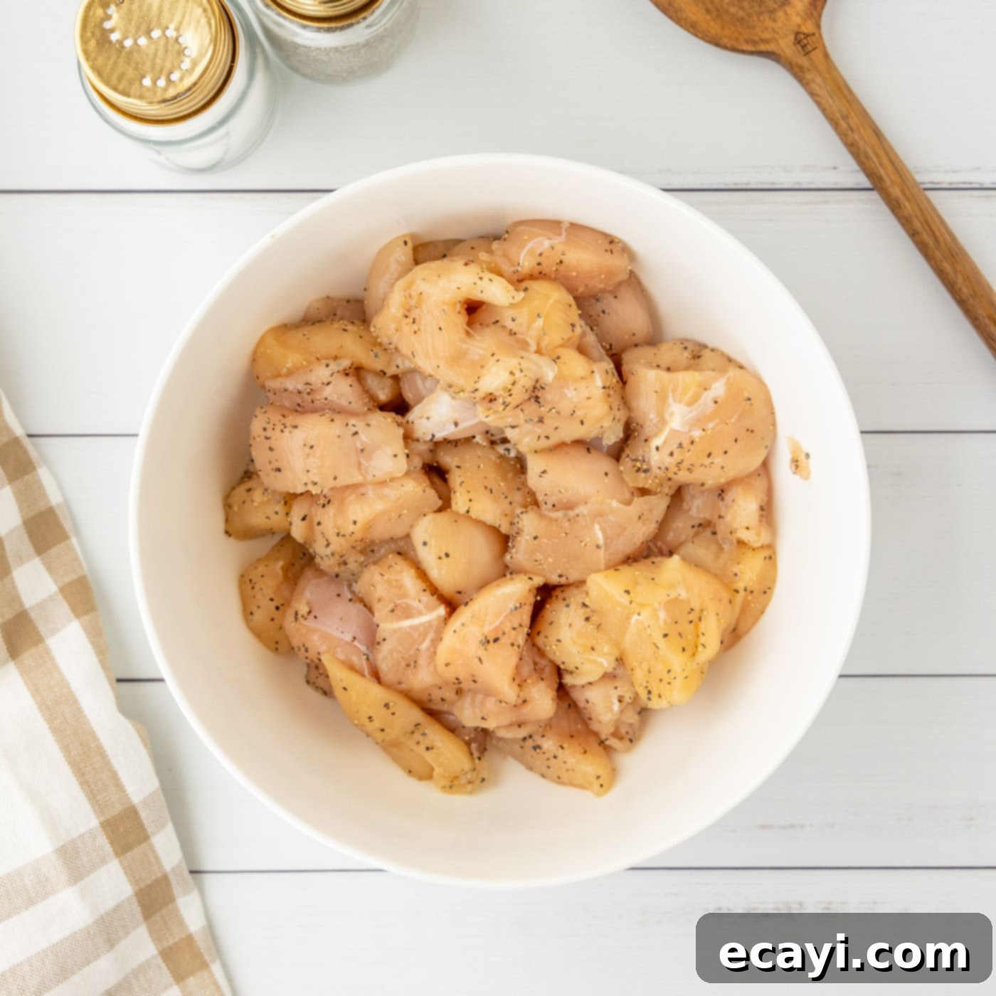 Sticky Bourbon Glazed Chicken 5 chicken seasoned with salt and pepper in a bowl