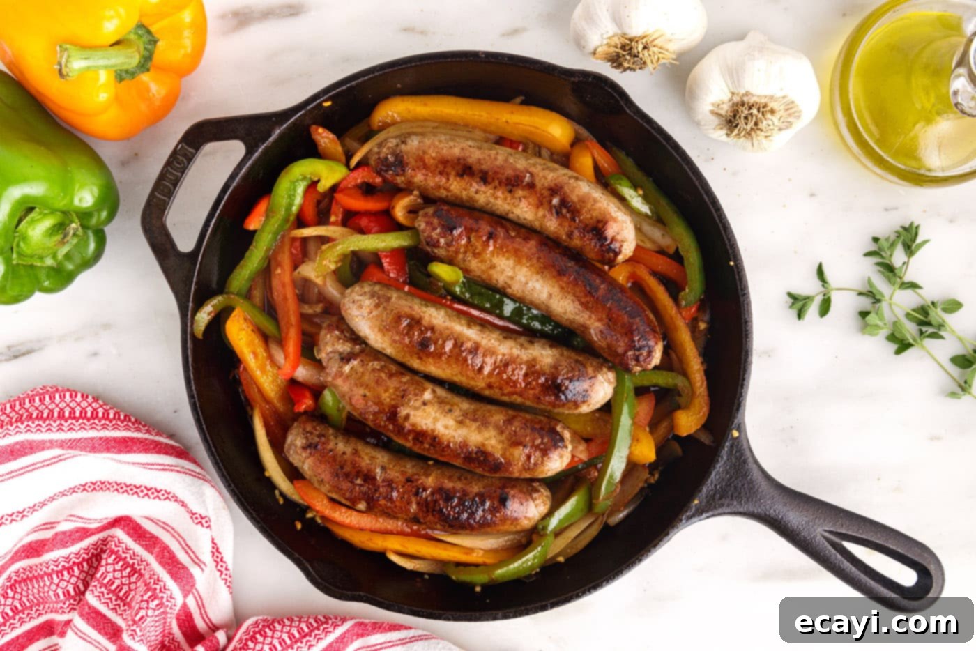 Sausage and Pepper Sizzle 11 Sausage and peppers baking in a skillet in the oven, with the sausages returned to the vegetable mixture.
