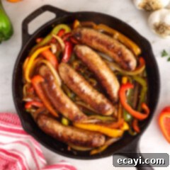 Sausage and Pepper Sizzle 13 A skillet full of savory sausage and peppers, glistening with sauce and ready to serve.
