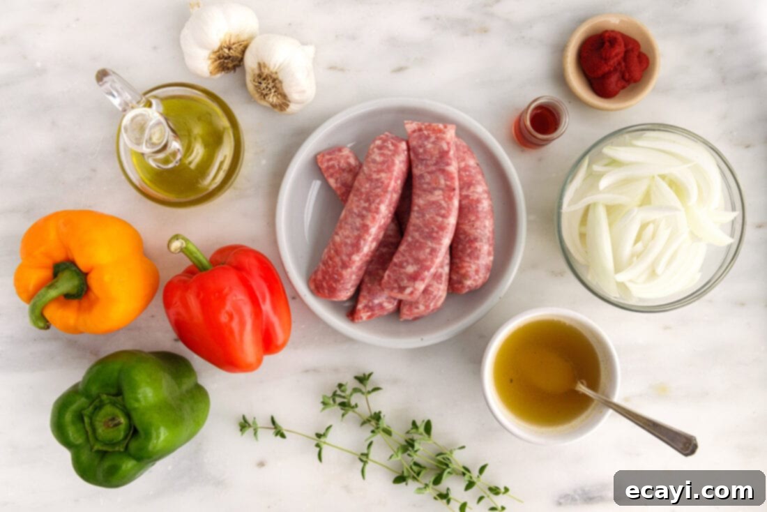 Sausage and Pepper Sizzle 4 Essential ingredients laid out on a cutting board, including colorful bell peppers, Italian sausage, onion, and garlic for making sausage and peppers.
