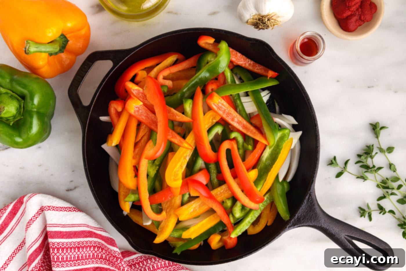 Sausage and Pepper Sizzle 7 Colorful julienned bell peppers and sliced onions sautéing in a skillet, creating a flavorful base.