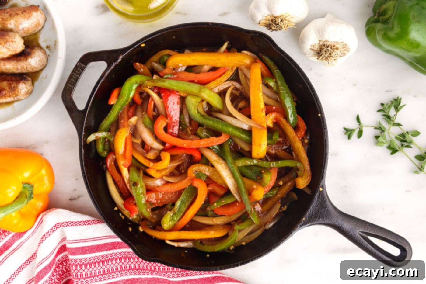 Sausage and Pepper Sizzle 10 Sautéed peppers and onions simmering in a skillet with red wine vinegar and broth, creating a flavorful sauce.