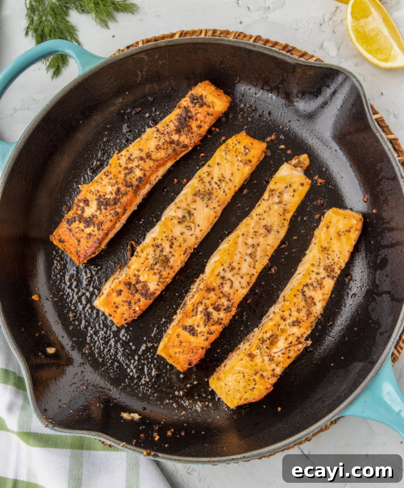 Golden Pan-Seared Salmon 6 Salmon pan fried in a skillet, showing the crispy exterior