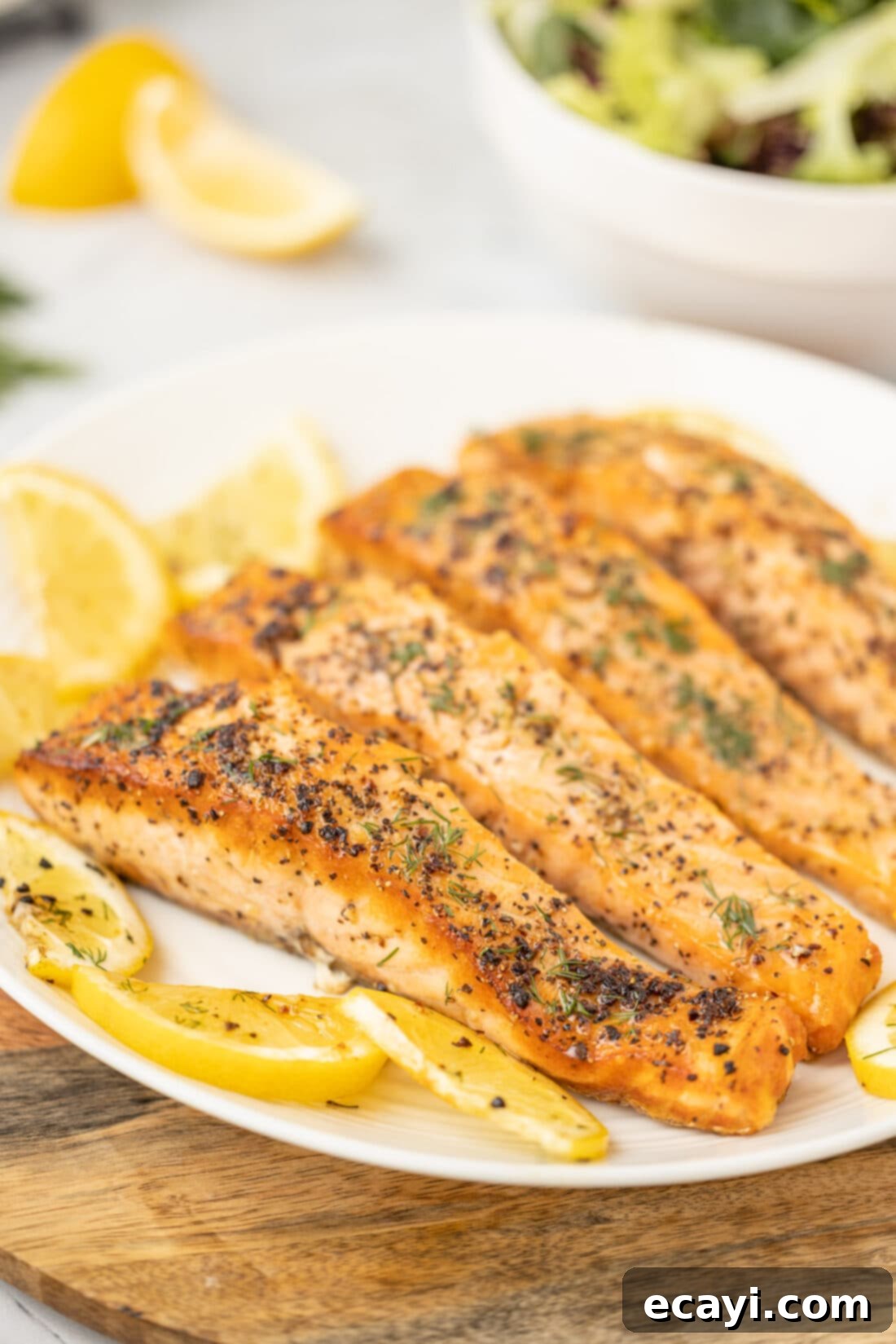 Golden Pan-Seared Salmon 7 Plated Pan Seared Salmon with a lemon wedge and fresh herbs