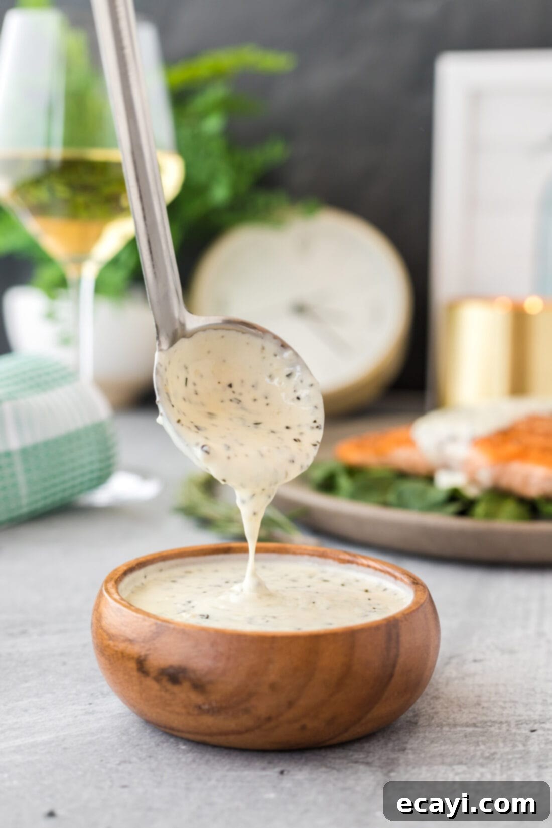Aromatic Rosemary Cream Sauce 2 Ladle of golden Rosemary Cream Sauce ready to be served over a dish.