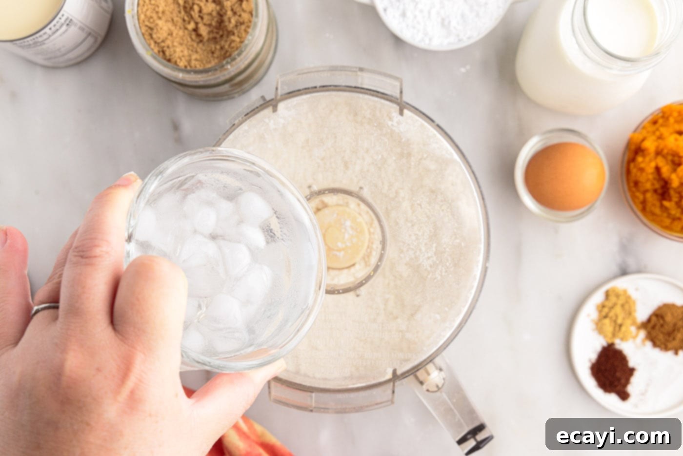 Pumpkin Pie Bites 6 pouring ice water into food processor with flour and butter