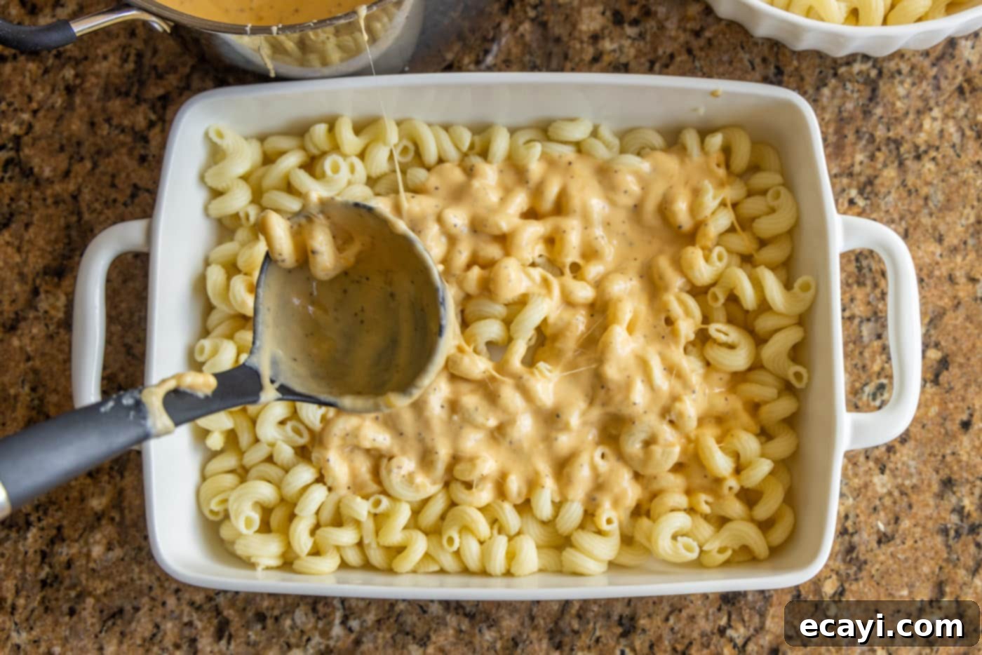 Decadent Lobster Mac and Cheese 9 pasta on ladle over mac and cheese