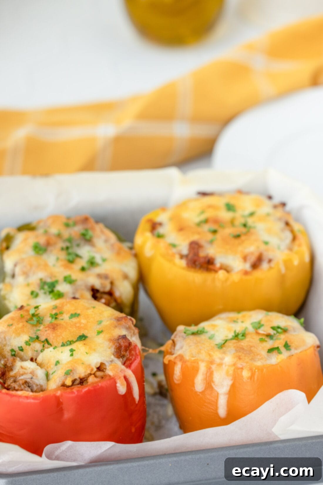 Hearty Stuffed Bell Pepper Bake 2 Classic Stuffed Bell Peppers in a baking dish, fresh from the oven, showcasing their vibrant colors and cheesy topping.