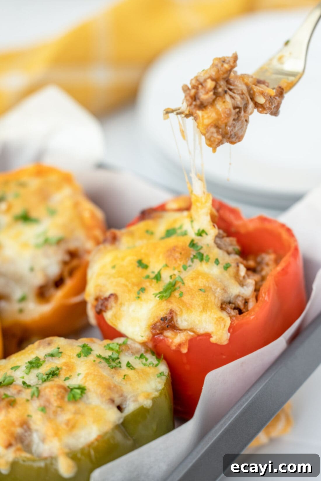 Hearty Stuffed Bell Pepper Bake 11 A forkful of stuffed pepper showing the cheesy, meaty, and rice filling inside the tender bell pepper.