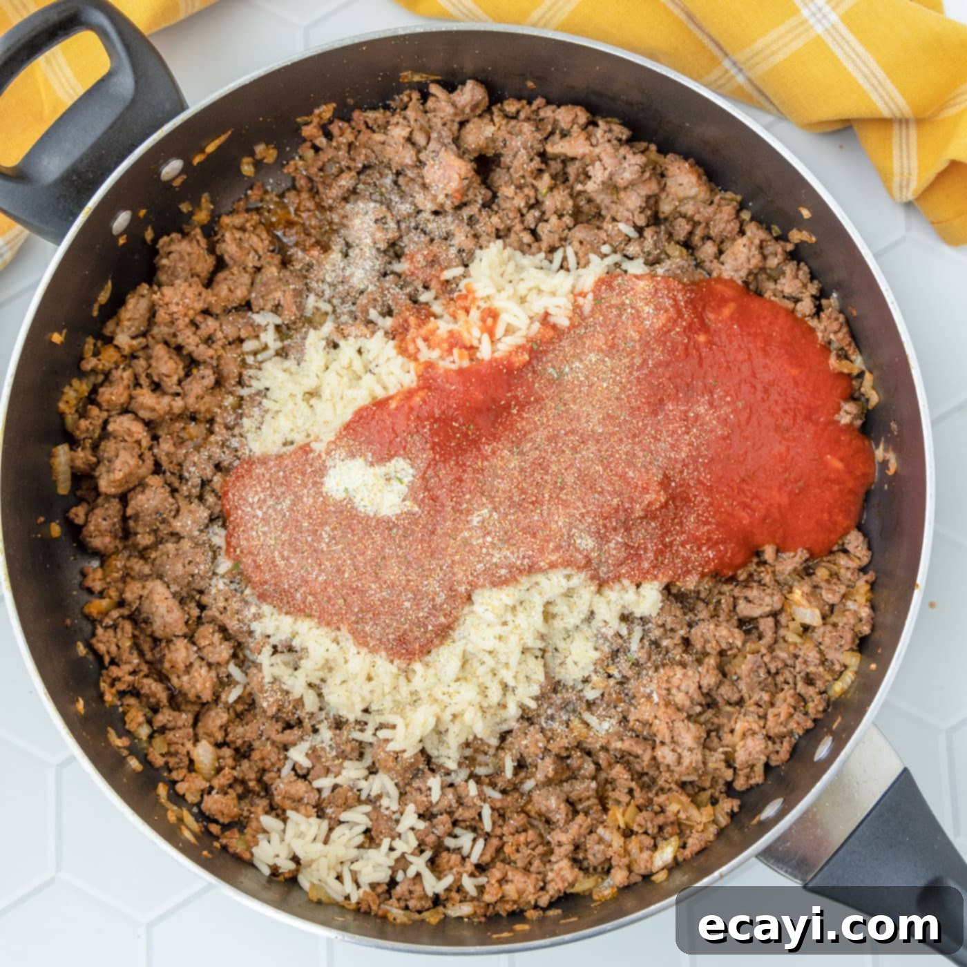 Hearty Stuffed Bell Pepper Bake 9 Beef mixture with tomato sauce and rice fully combined in a skillet.