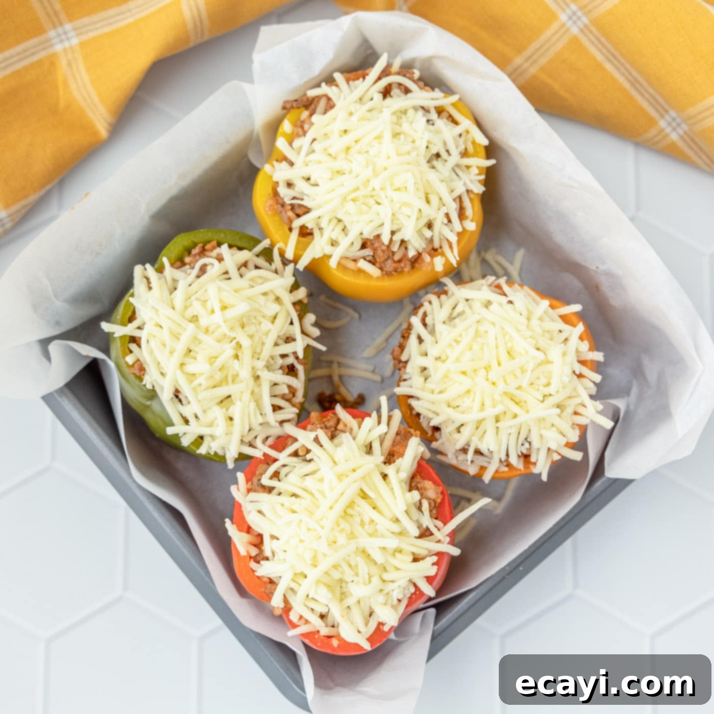Hearty Stuffed Bell Pepper Bake 10 Stuffed peppers topped with cheese in a baking dish, ready for the oven.
