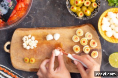Eye-Popping Halloween Dip 13 scooping a hole into the center of mozzarella ball
