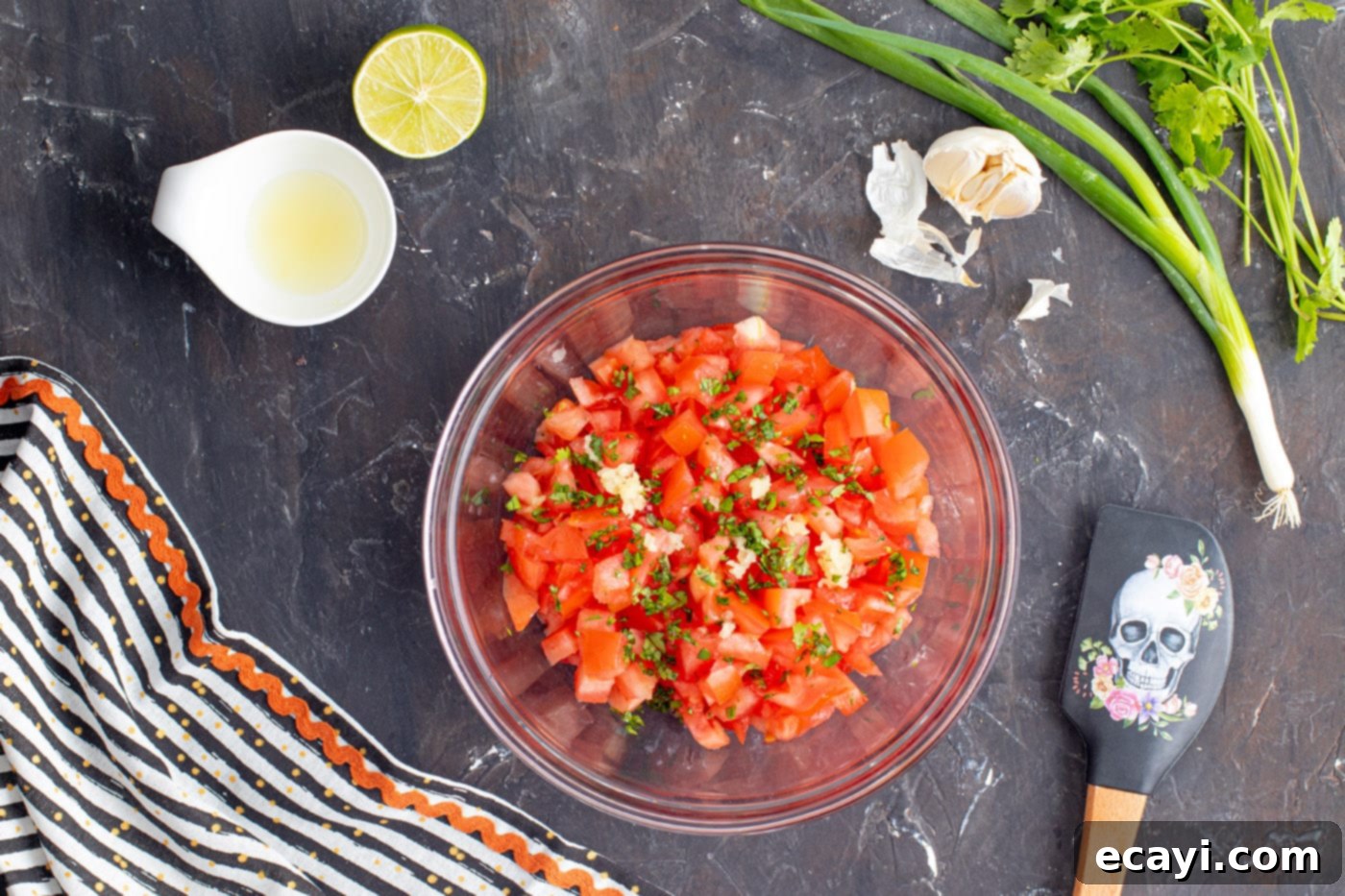 Eye-Popping Halloween Dip 5 pico de gallo ingredients in a mixing bowl