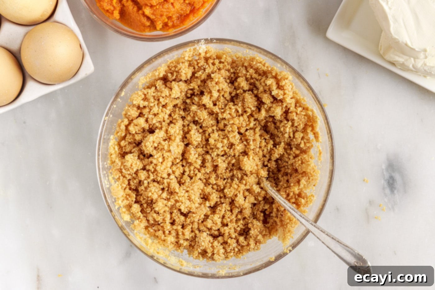 Spiced Mini Pumpkin Cheesecakes 6 graham cracker crust ingredients in a bowl