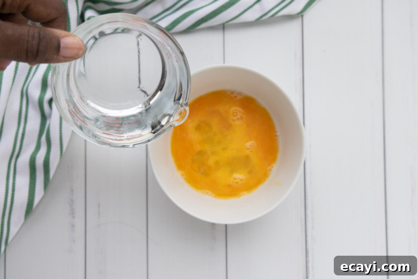 Golden Crispy Fanned Shrimp 8 pouring water into eggs in a bowl