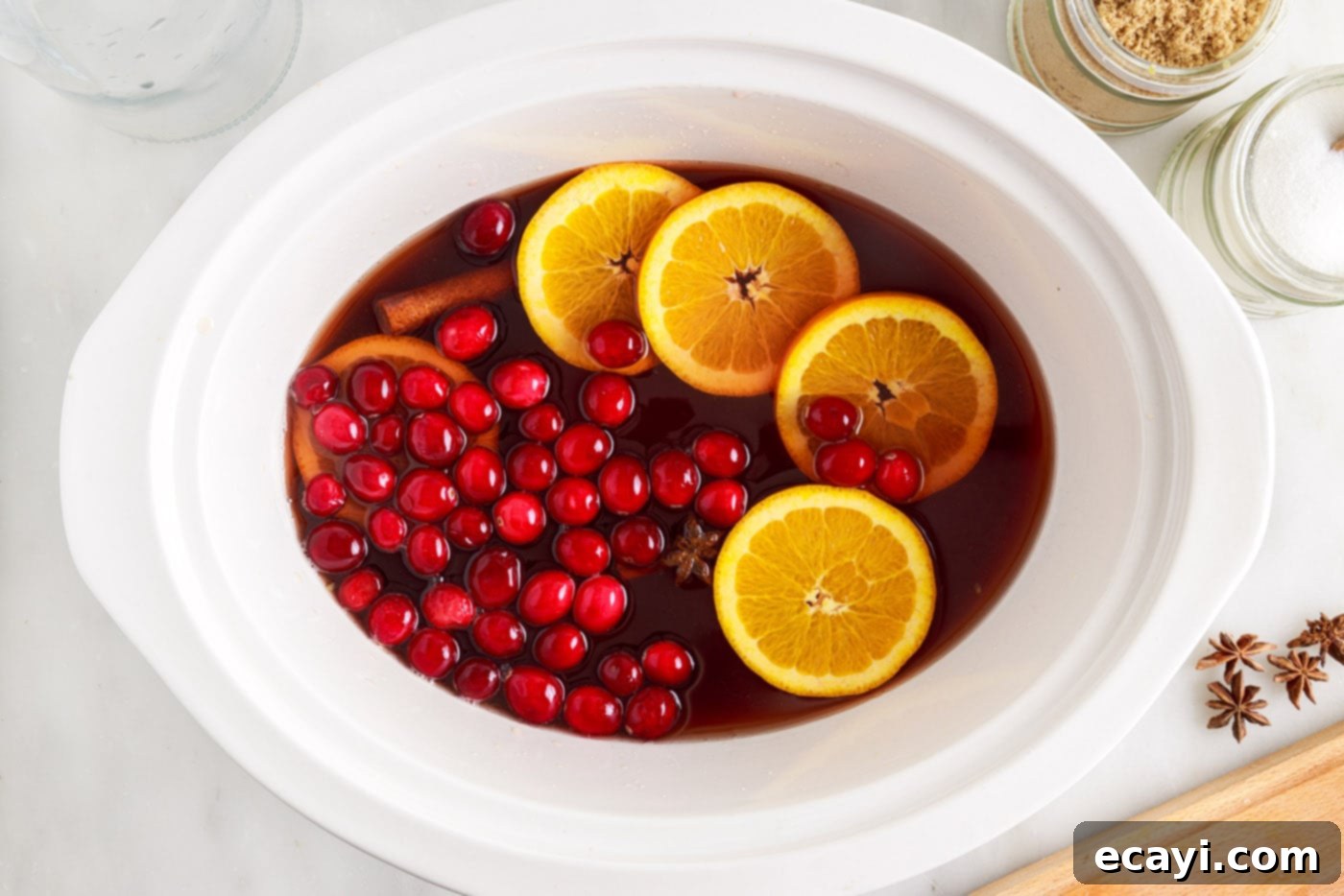 Mulled Cranberry Cheer 7 orange slices and cranberries in hot cranberry punch in the slow cooker