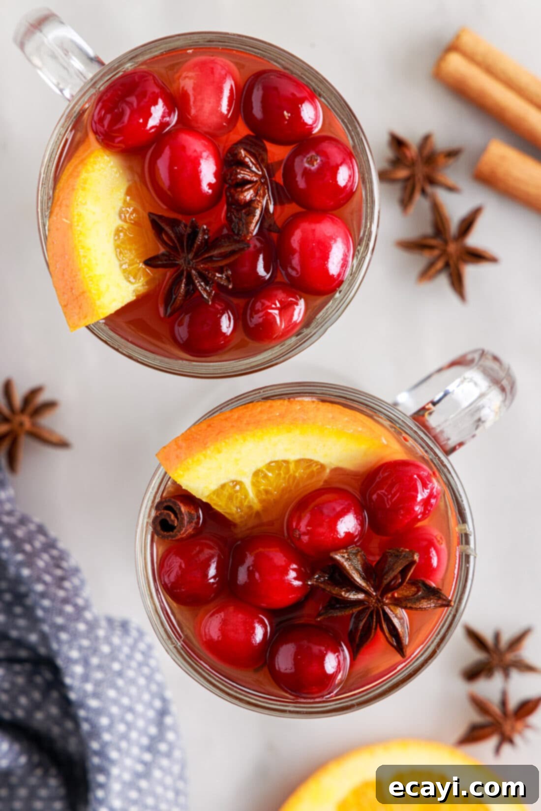 Mulled Cranberry Cheer 8 mugs of Hot Cranberry Punch garnished with orange slices and cranberries