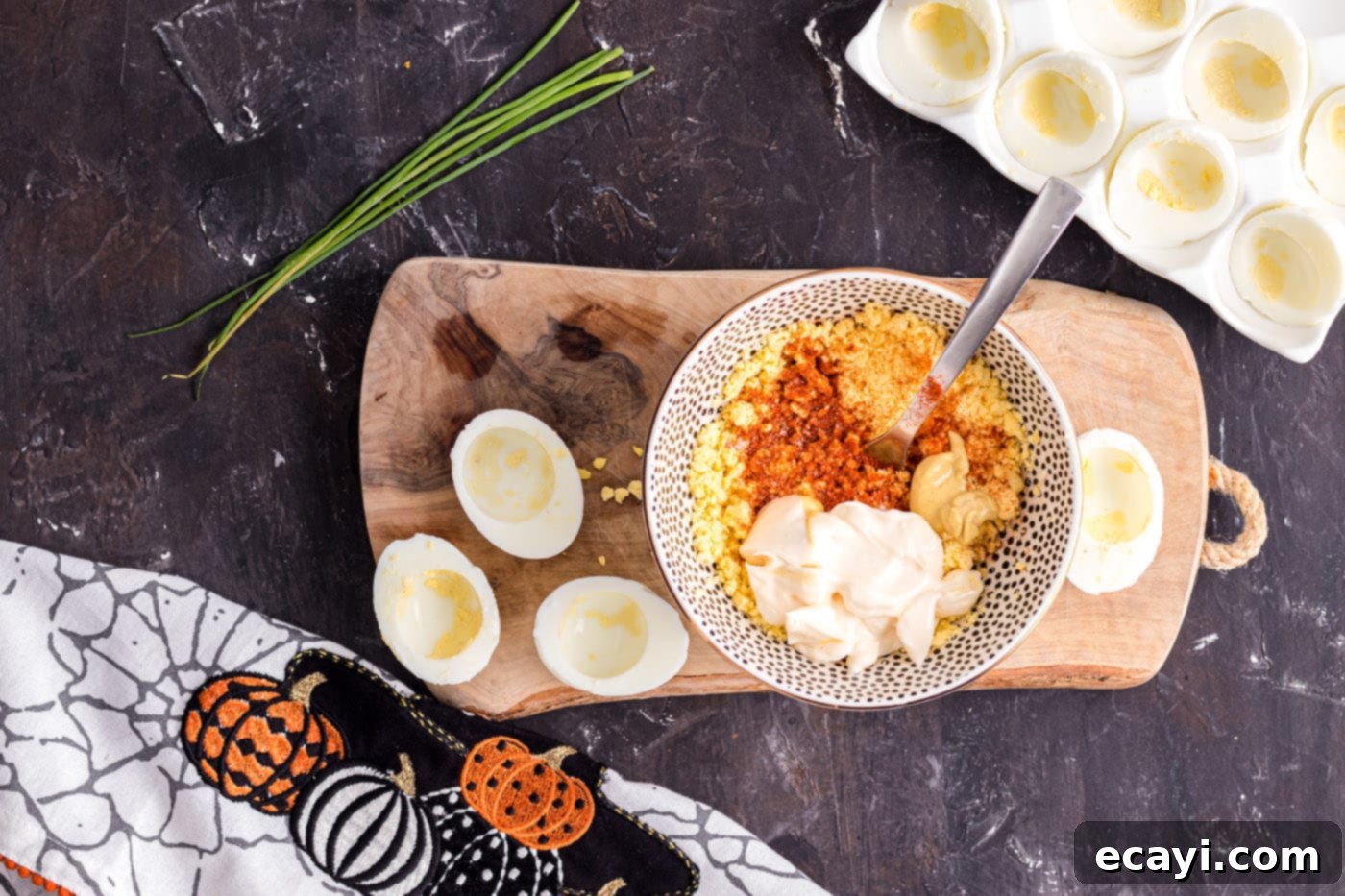 Creamy Pumpkin Deviled Delights 6 mashing deviled egg ingredients in a bowl to create a smooth filling