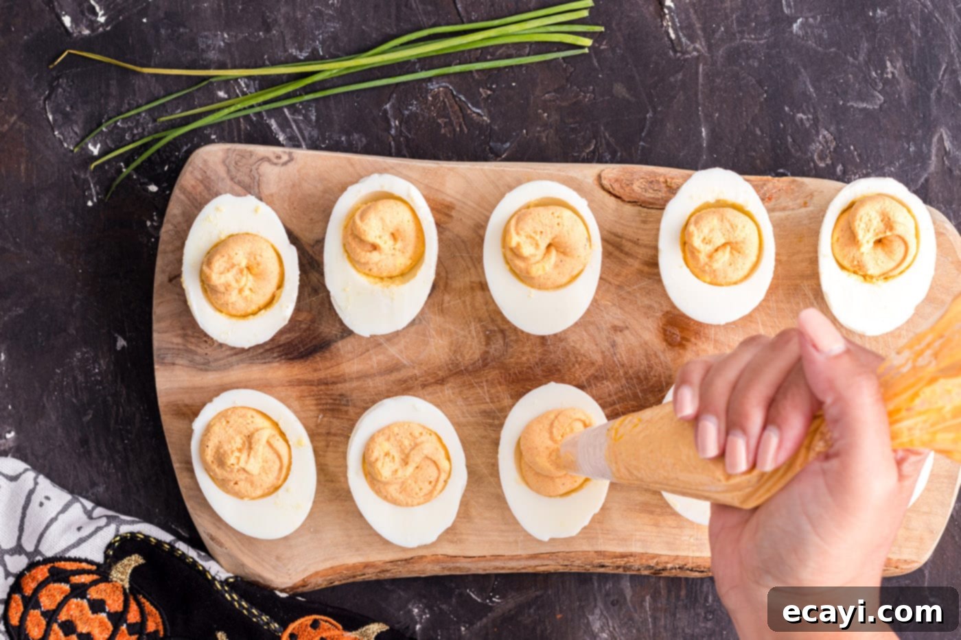 Creamy Pumpkin Deviled Delights 7 piping egg yolk mixture into the centers of egg whites