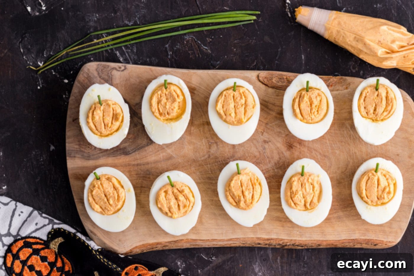 Creamy Pumpkin Deviled Delights 9 easy pumpkin deviled eggs with chives, ready for garnish