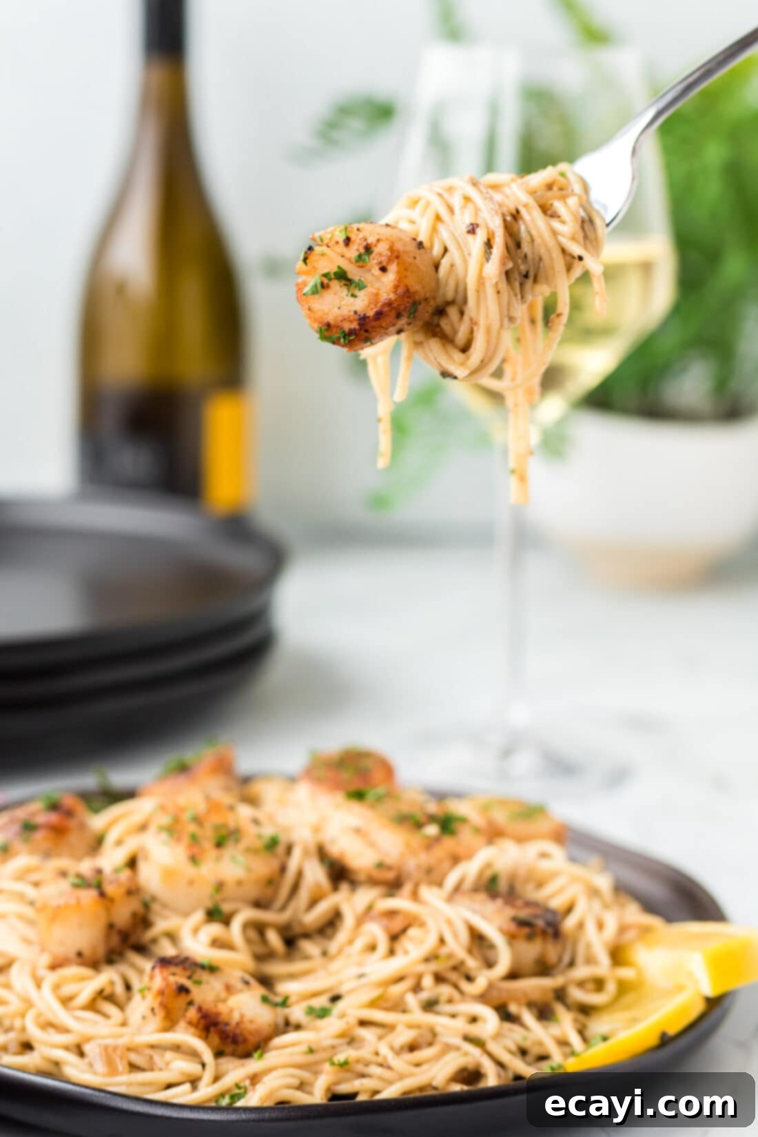 Creamy Lemon Scallop Pasta 8 fork lifting some Scallop Pasta