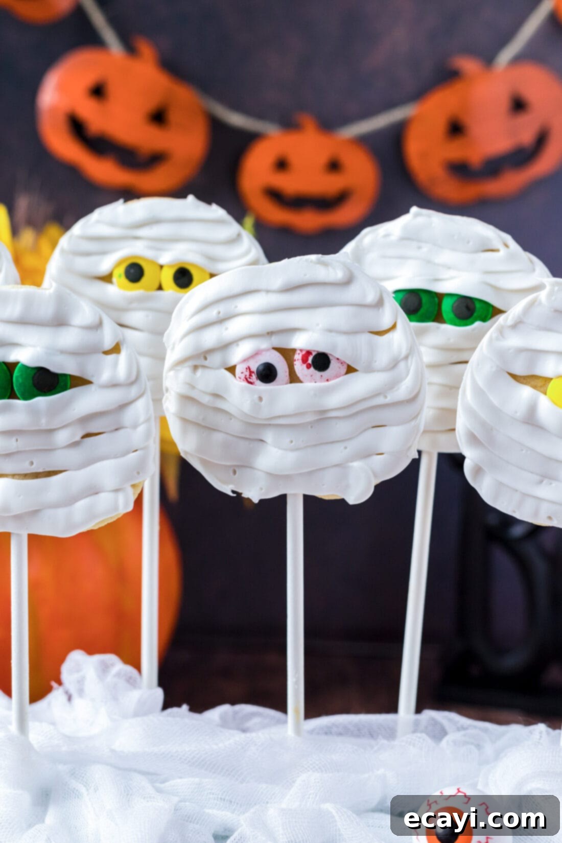 Spooktacular Mummy Cookies 2 Mummy Cookies with pumpkin banner