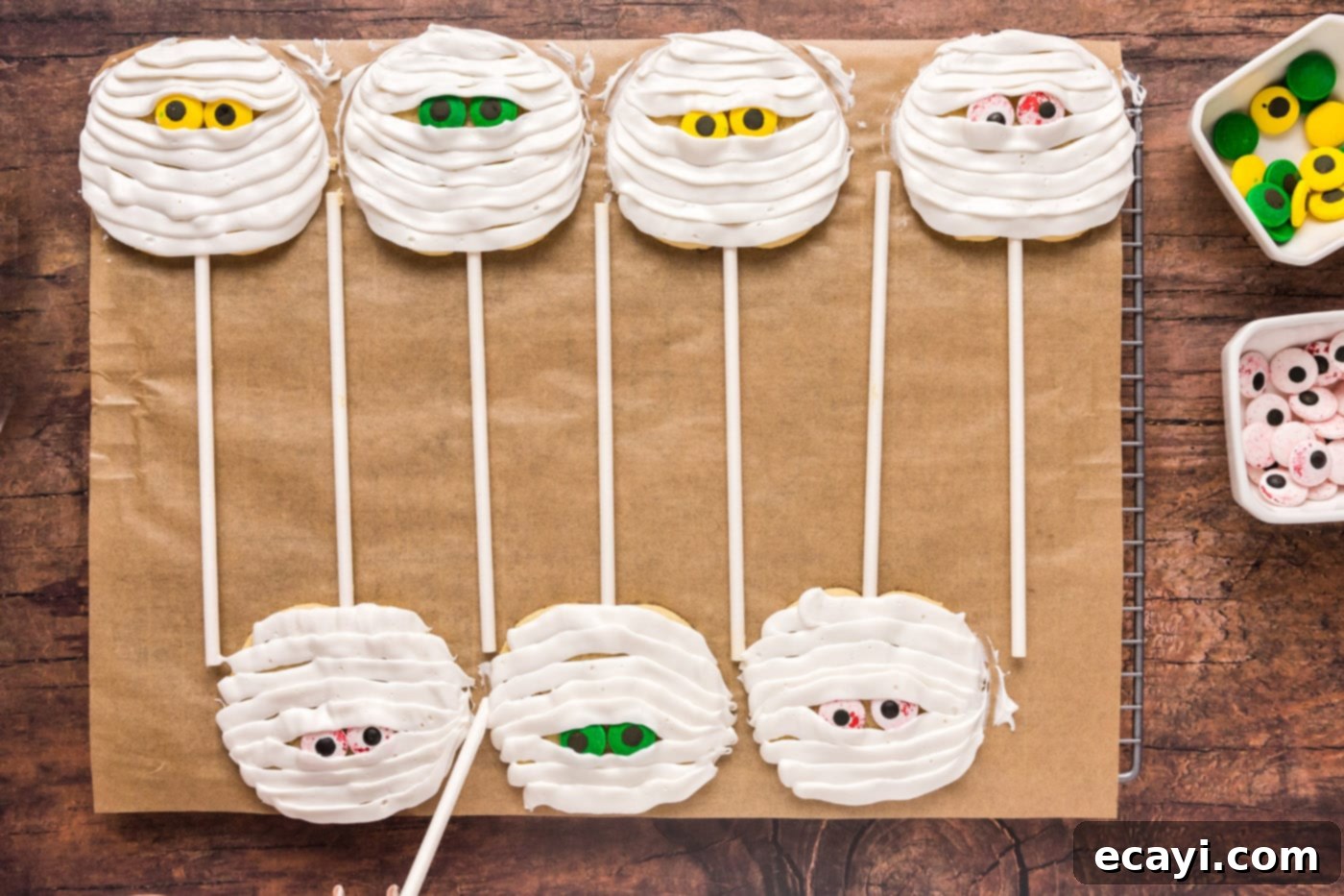 Spooktacular Mummy Cookies 11 mummy cookie pops on a baking sheet