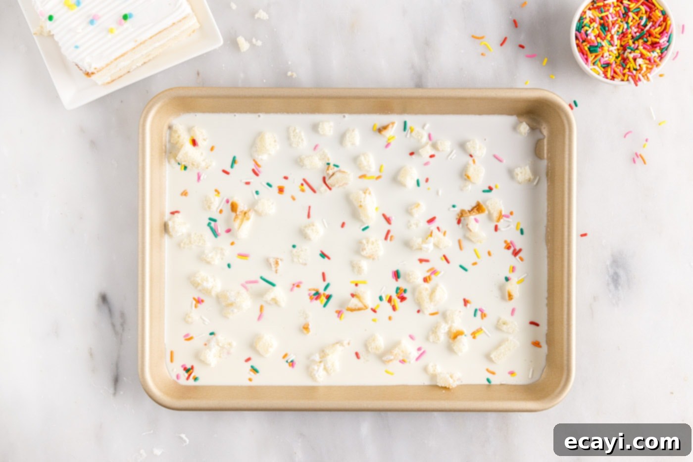 Confetti Cake Swirls 8 Birthday cake ice cream mixture with sprinkles and cake crumbles spread on a sheet pan.