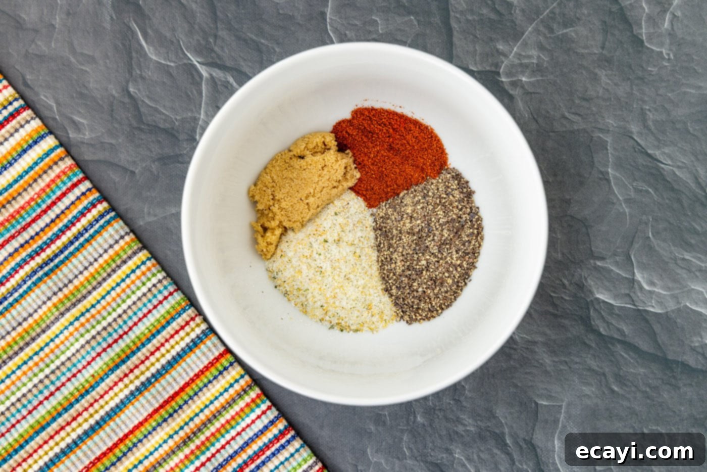Gourmet Lamb Lollipops 5 A bowl filled with a perfectly blended spice rub, ready to season the lamb chops.