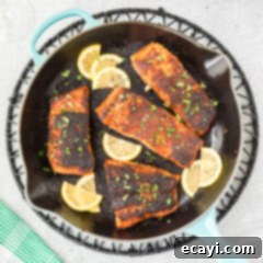 Cajun Seared Salmon 13 Blackened Salmon in a skillet, showcasing its dark, crispy crust ready to be served.