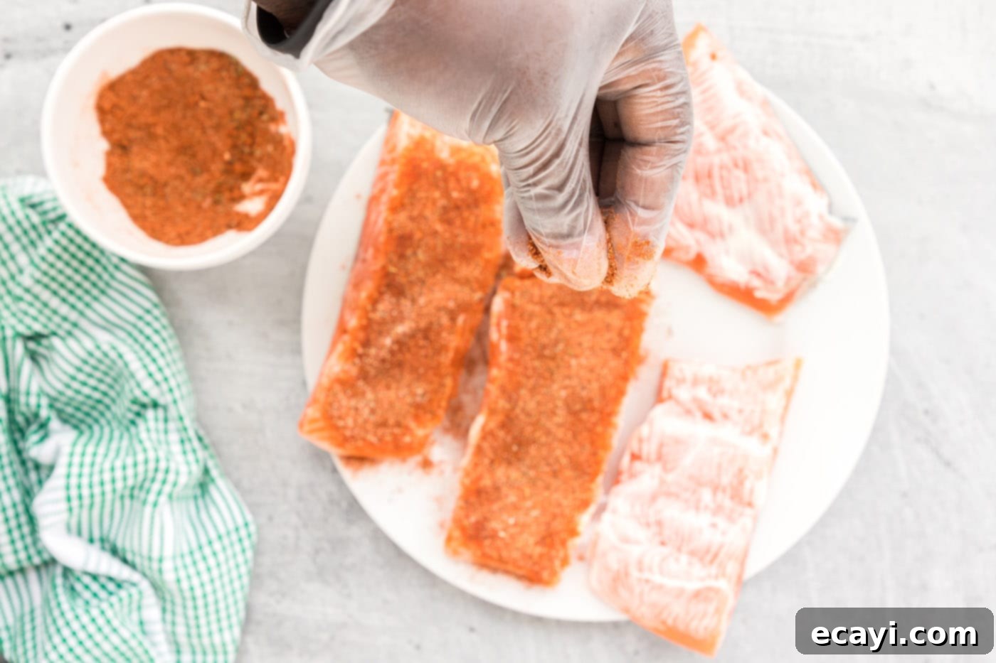 Cajun Seared Salmon 6 Salmon fillets generously coated with blackened seasoning, ready for pan-searing.