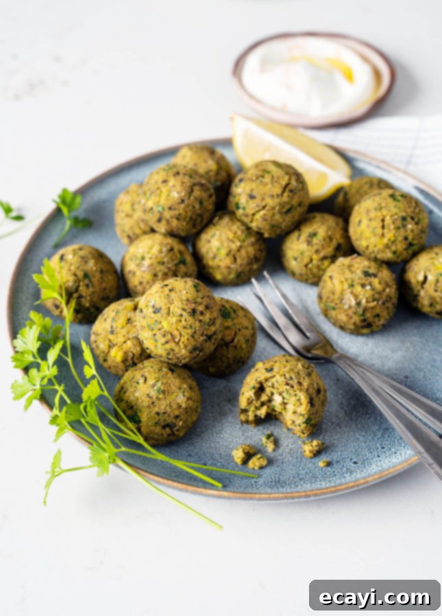 Light & Nutty Baked Pistachio Falafels 5 Golden Oven-Baked Pistachio Falafels ready to be enjoyed, served in a bowl with herbs.