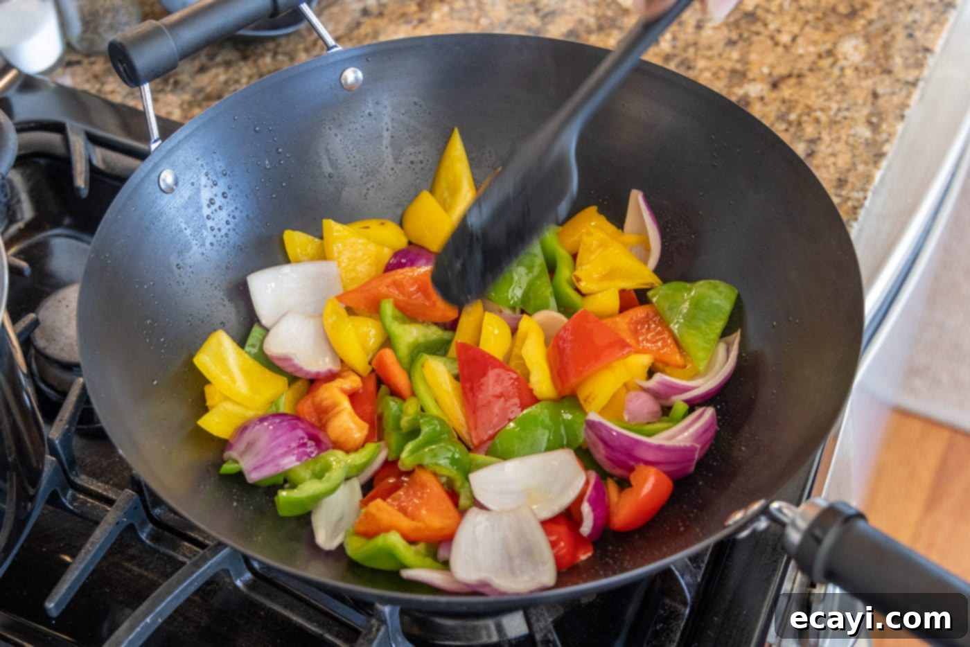 Zesty Peppercorn Shrimp 12 Vibrant bell peppers and red onions being stir-fried in a hot wok.