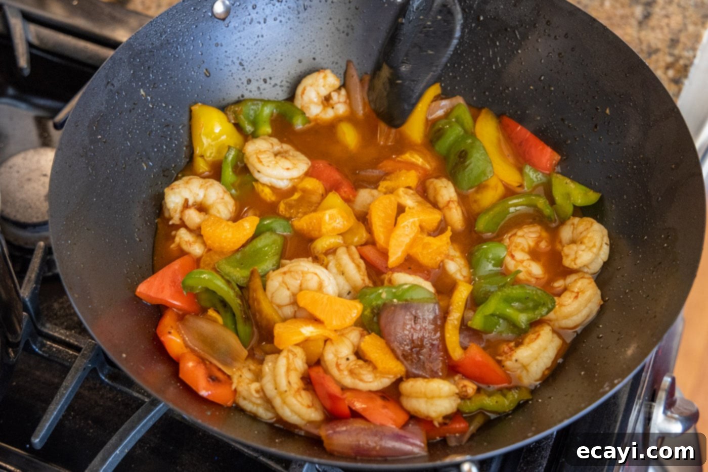 Zesty Peppercorn Shrimp 15 The finished Citrus Pepper Shrimp, coated in sauce and mixed with vegetables, still in the wok.