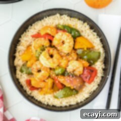 Zesty Peppercorn Shrimp 17 Citrus Pepper Shrimp in a bowl with chopsticks, ready to be enjoyed.