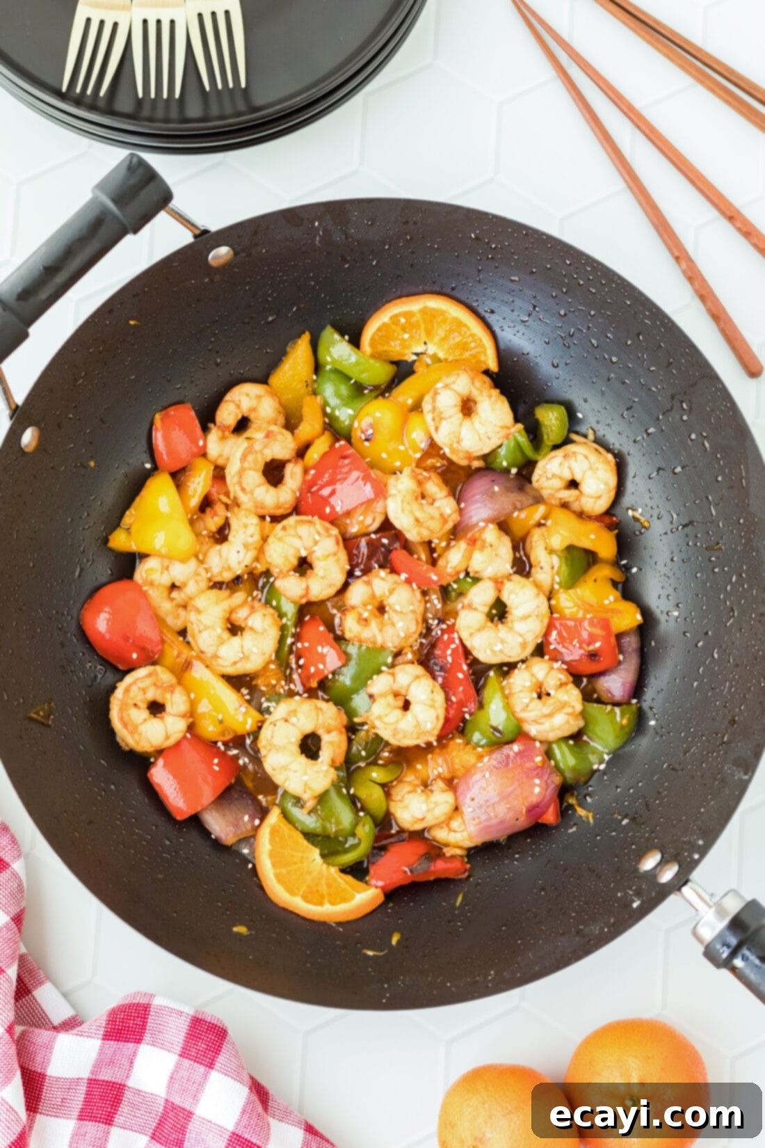 Zesty Peppercorn Shrimp 3 A close-up shot of Citrus Pepper Shrimp stir-frying in a large wok, showcasing the vibrant colors of the shrimp, bell peppers, and onions.
