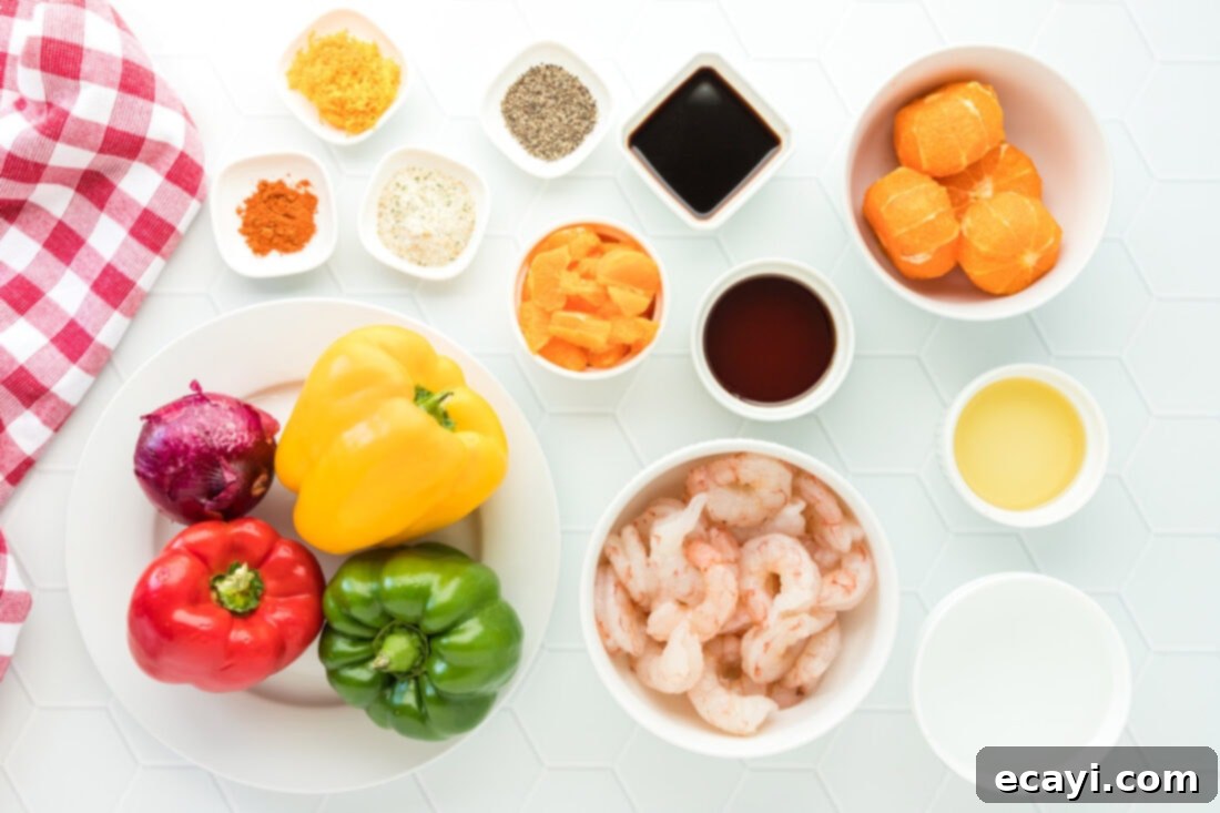 Zesty Peppercorn Shrimp 4 All the fresh ingredients for Citrus Pepper Shrimp laid out on a wooden cutting board, including shrimp, clementines, bell peppers, and spices.
