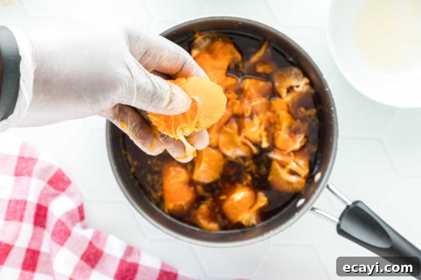 Zesty Peppercorn Shrimp 9 The clementine sauce mixture simmering gently in a saucepan, infusing with flavor.