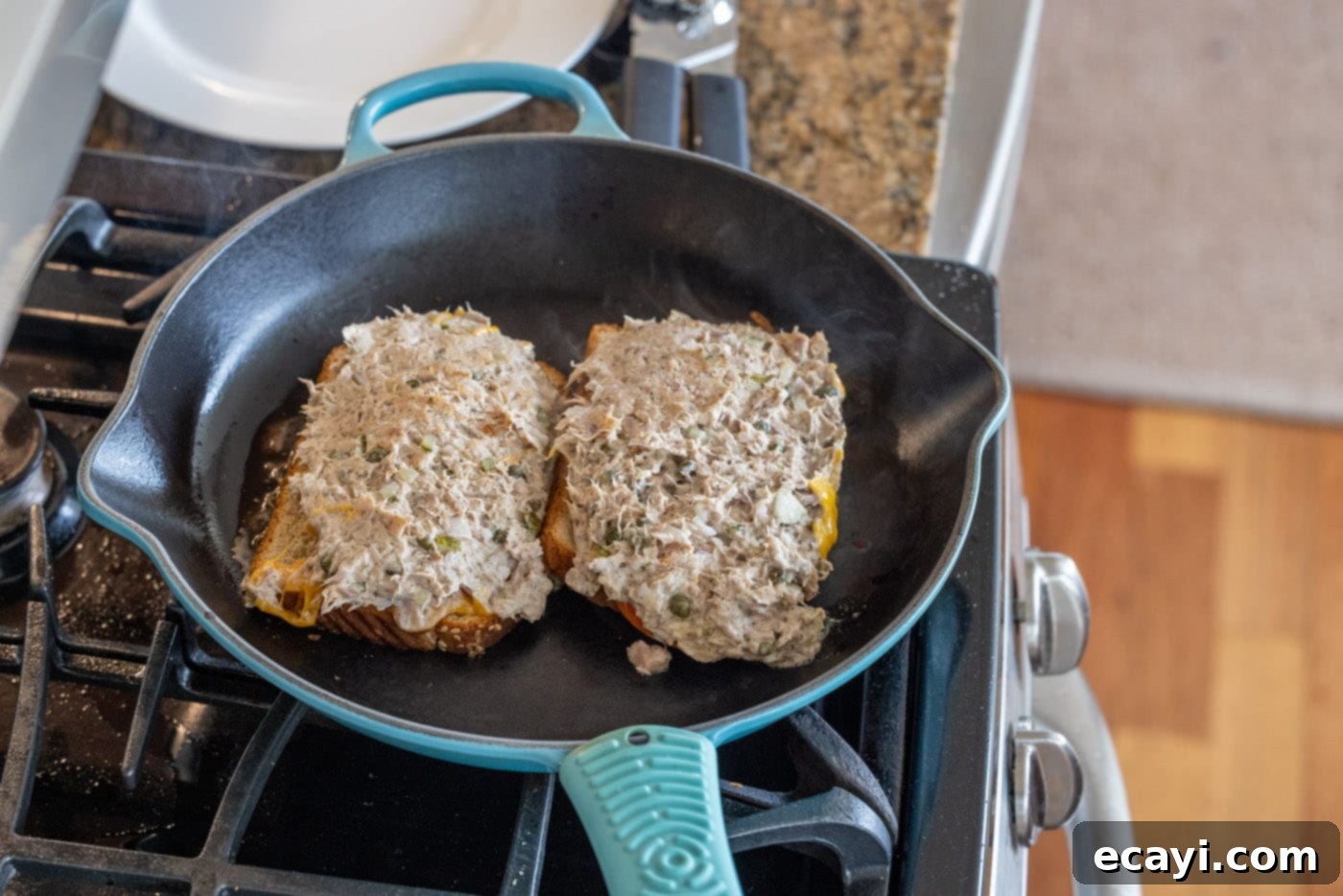 Golden Tuna Grille 13 Two tuna melts cooking side-by-side on the stovetop, achieving a beautiful golden crust.
