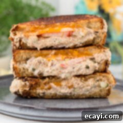 Golden Tuna Grille 18 A stack of golden brown tuna melts, cut in half to show the filling.