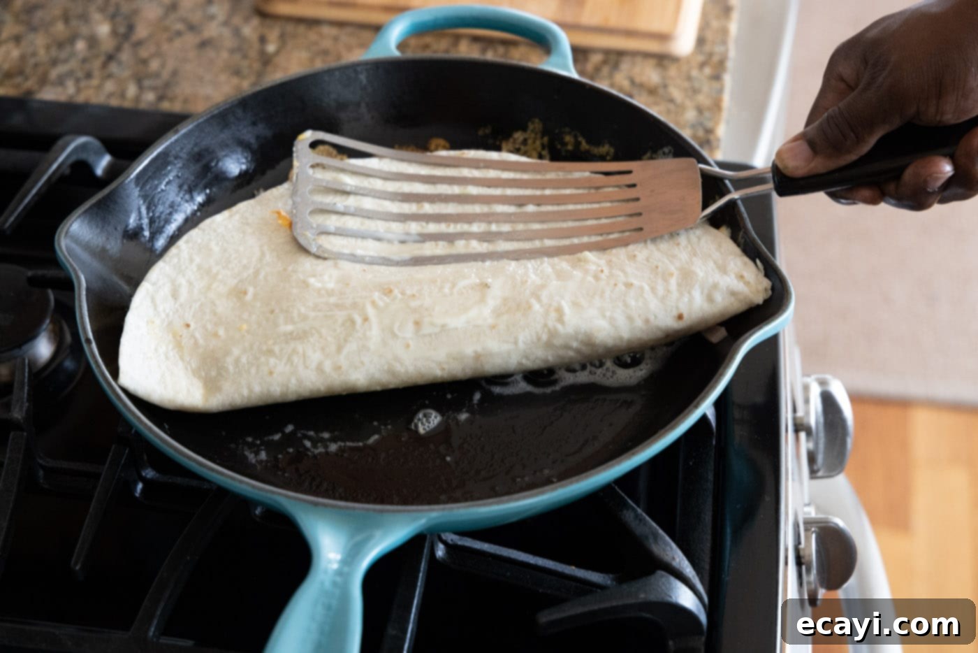 Savory Chicken Quesadilla 14 pressing chicken quesadilla into skillet