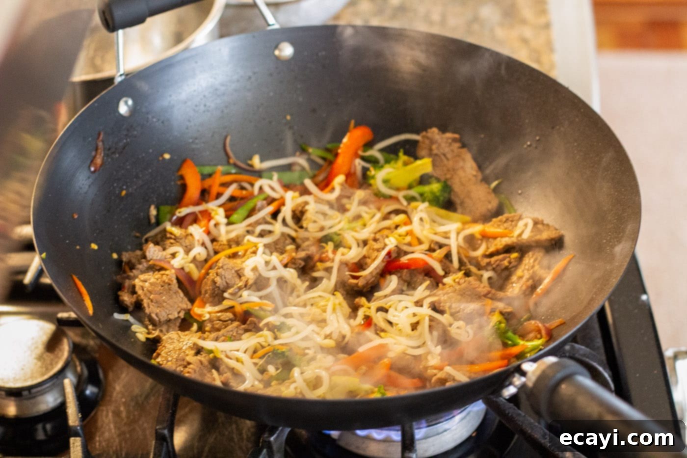 Ultimate Beef Lo Mein 12 bean sprouts added to beef lo mein in a wok