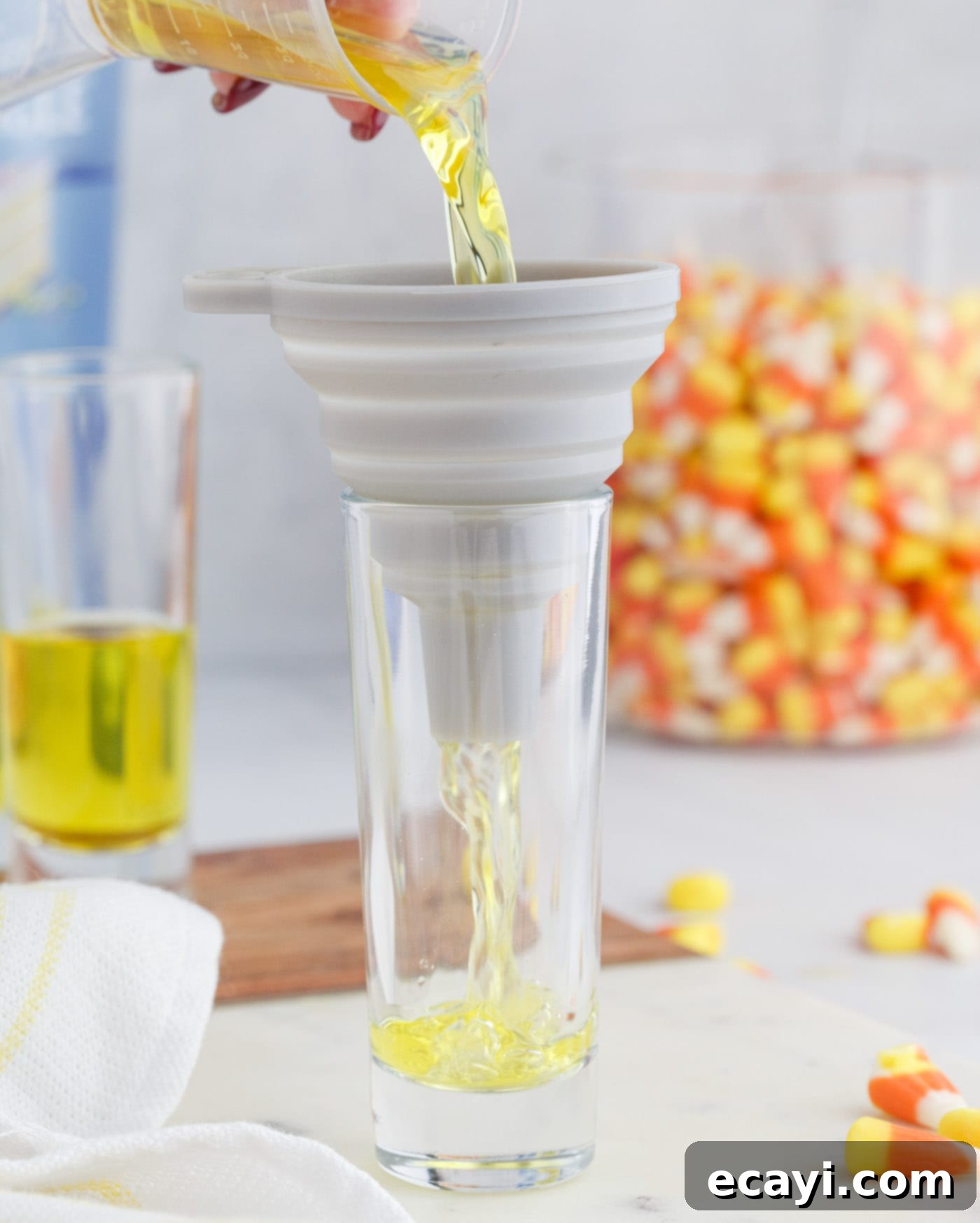 Harvest Hues Shooters 6 pouring jello mix into shot glass