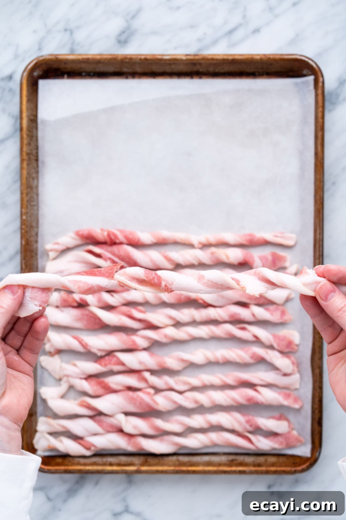 Crispy Bacon Spirals 6 Arranging twisted bacon on a baking tray lined with parchment paper