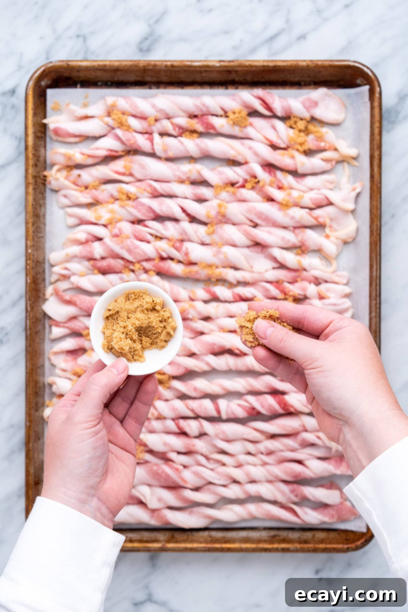 Crispy Bacon Spirals 7 Sprinkling brown sugar mixture over twisted raw bacon