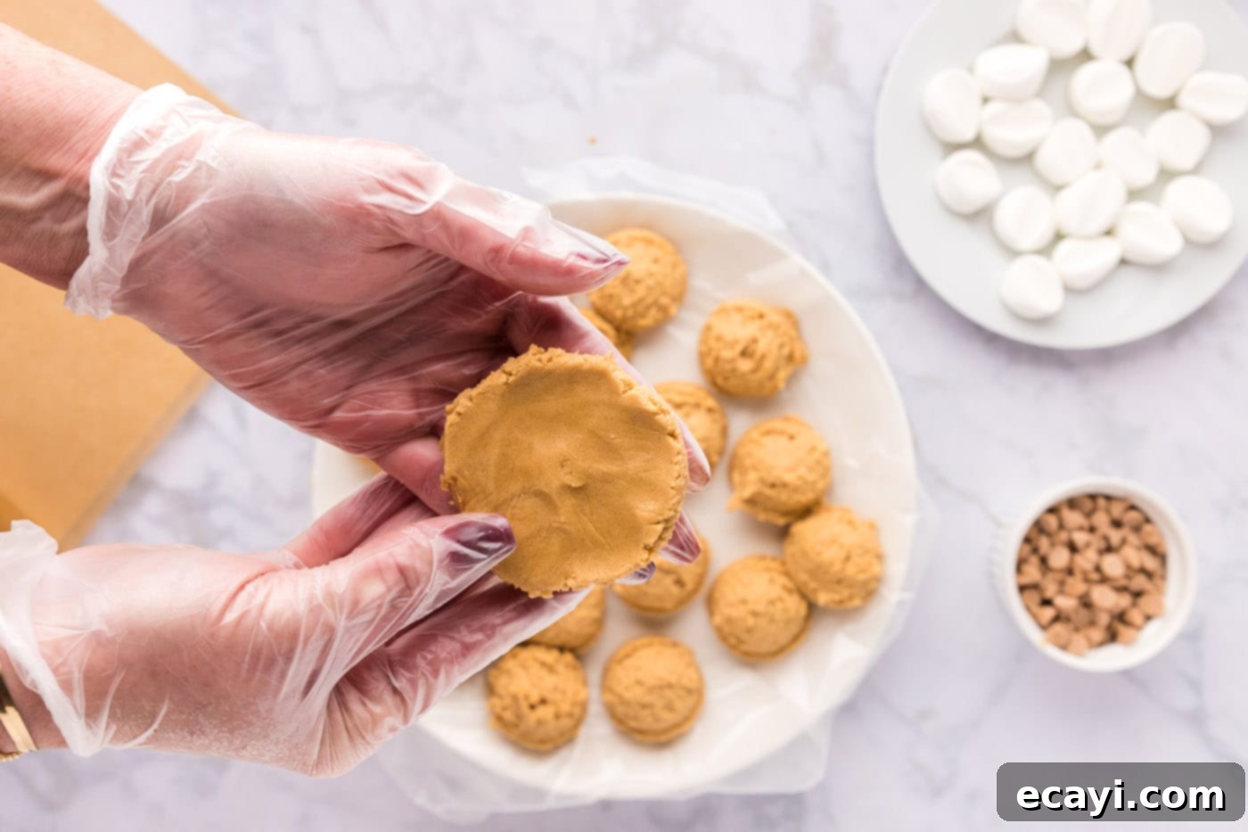 Sweet & Salty Fluffernutter Delights 14 flattening a peanut butter cookie dough ball in hand