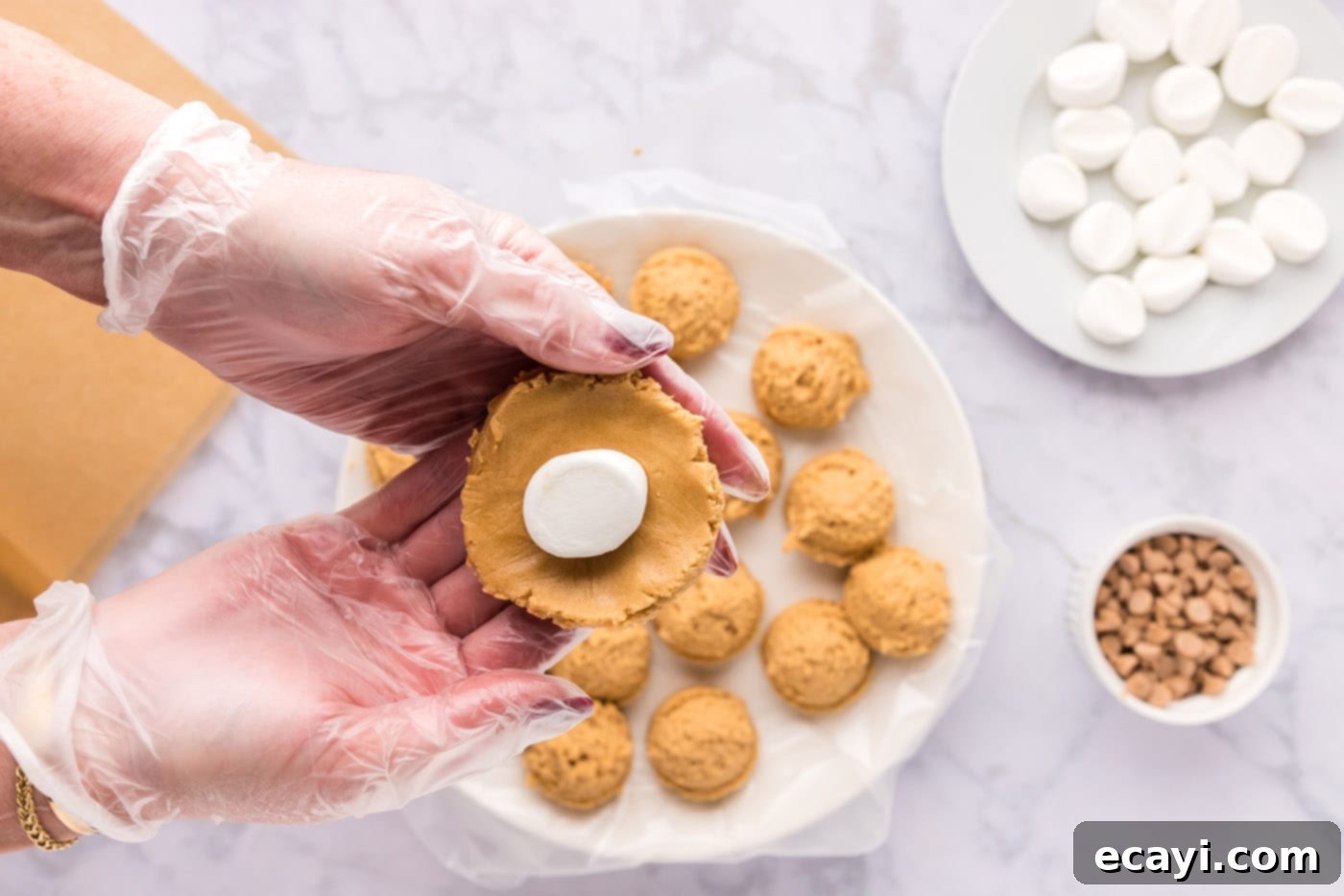 Sweet & Salty Fluffernutter Delights 15 inserting half of a frozen marshmallow into the center of a peanut butter cookie dough ball
