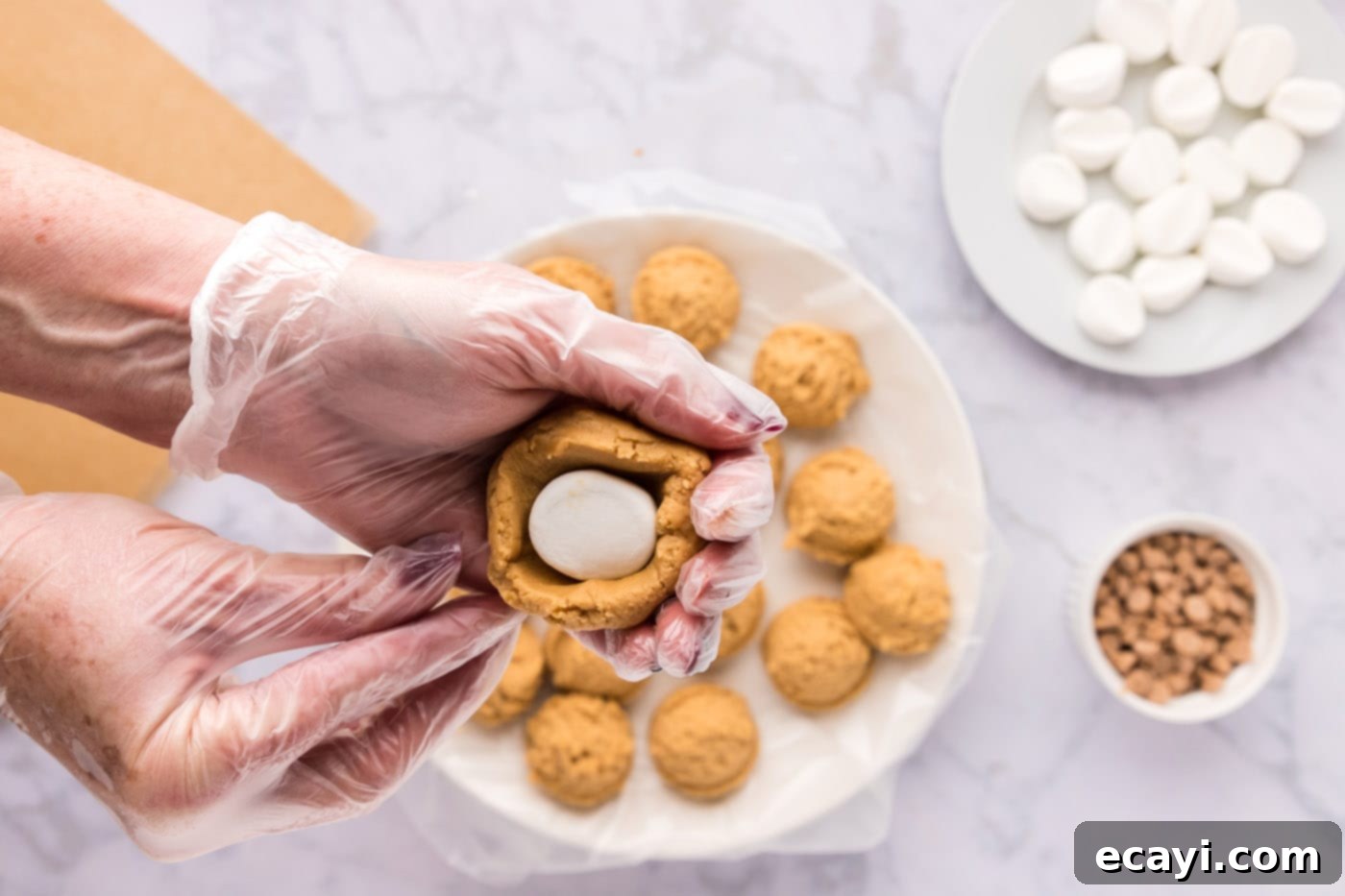 Sweet & Salty Fluffernutter Delights 16 squeezing peanut butter cookie dough over a marshmallow to seal it
