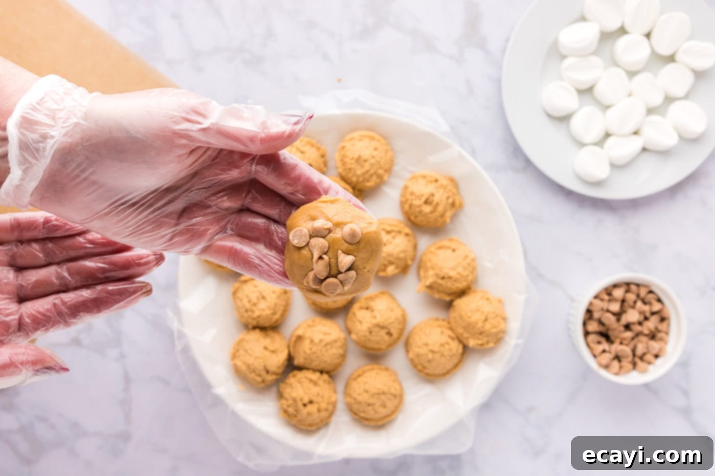 Sweet & Salty Fluffernutter Delights 20 fluffernutter cookie dough ball with peanut butter chips in hand, ready for baking